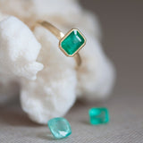 An emerald cut portrait ring set on a gold band